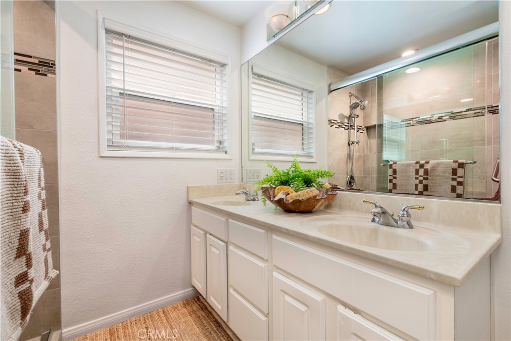 143 Roycroft Avenue Long Beach, CA 90803 - Photo 24 of 45 a bathroom with a sink and a mirror