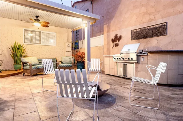 a living room with furniture a flat screen tv and kitchen view