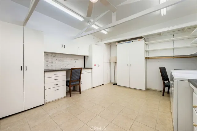 a view of an empty room with cabinet and entryway