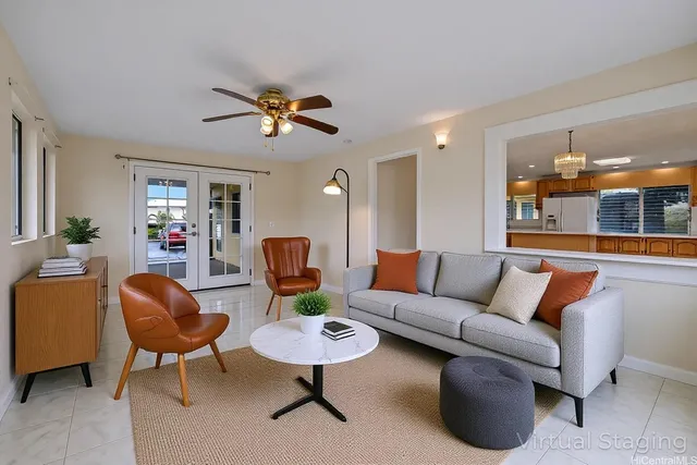 a living room with furniture a lamp and a chandelier