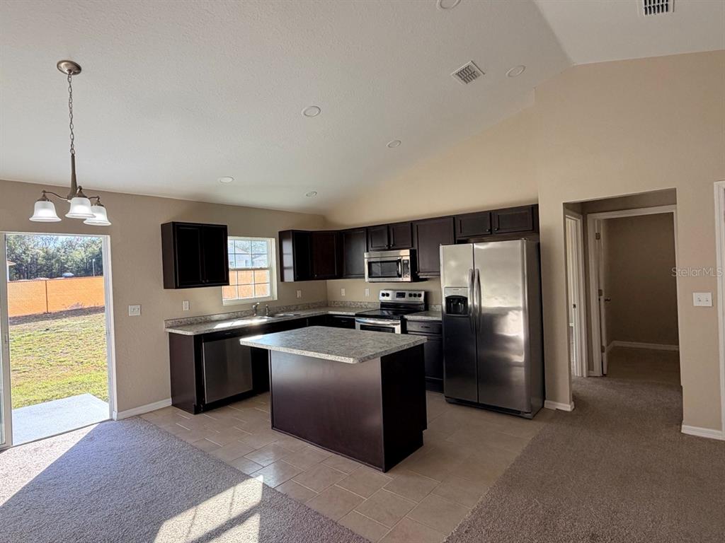 14656 Southwest 21st Place Ocala, FL 34481 - Photo 11 of 52 a kitchen with stainless steel appliances granite countertop a refrigerator stove a sink dishwasher and oven