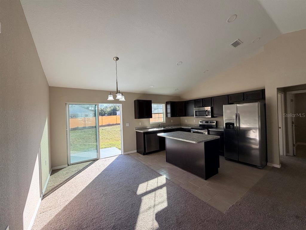 14656 Southwest 21st Place Ocala, FL 34481 - Photo 12 of 52 a kitchen with stainless steel appliances granite countertop a refrigerator and a sink