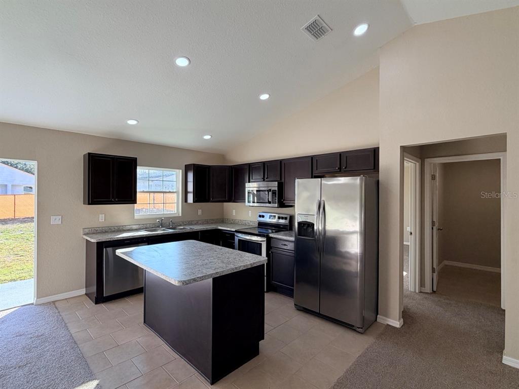 14656 Southwest 21st Place Ocala, FL 34481 - Photo 17 of 52 a large kitchen with stainless steel appliances granite countertop a refrigerator and a sink