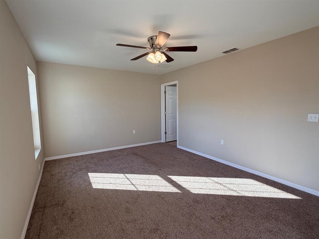 14656 Southwest 21st Place Ocala, FL 34481 - Photo 19 of 52 an empty room with a fan & a window