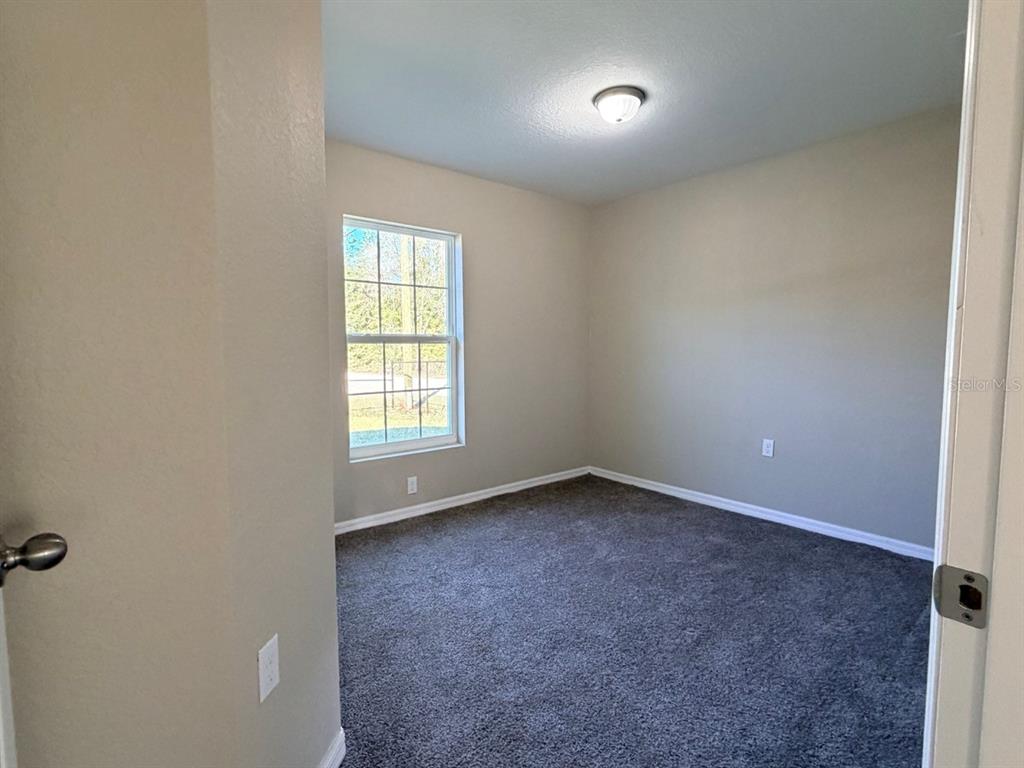 14656 Southwest 21st Place Ocala, FL 34481 - Photo 29 of 52 an empty room with a window
