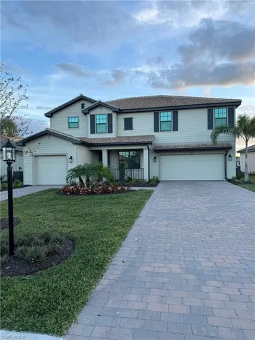 a front view of a house with a yard and garage