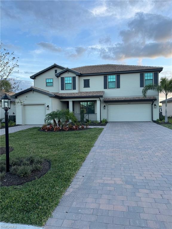 a front view of a house with a yard and garage