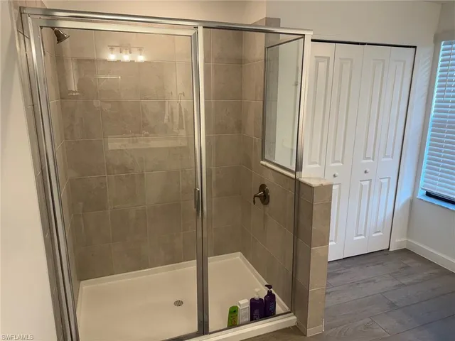 a bathroom with a glass shower door