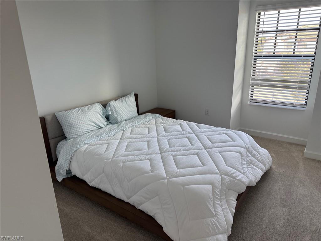 18227 Ridgeline Drive Estero, FL 33928 - Photo 16 of 30 a bed sitting in a bedroom next to a window
