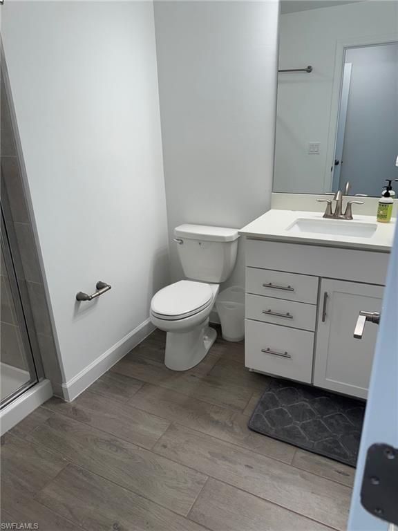 18227 Ridgeline Drive Estero, FL 33928 - Photo 24 of 30 a bathroom with a toilet a sink and mirror