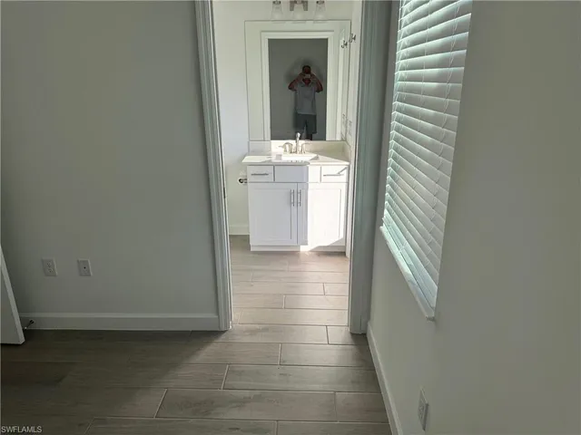 a view of a livingroom with wooden floor and stairs