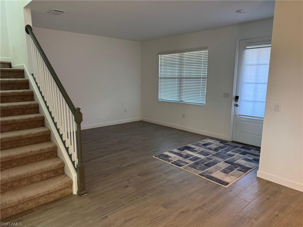 18227 Ridgeline Drive Estero, FL 33928 - Photo 30 of 30 a view of a livingroom with wooden floor and stairs