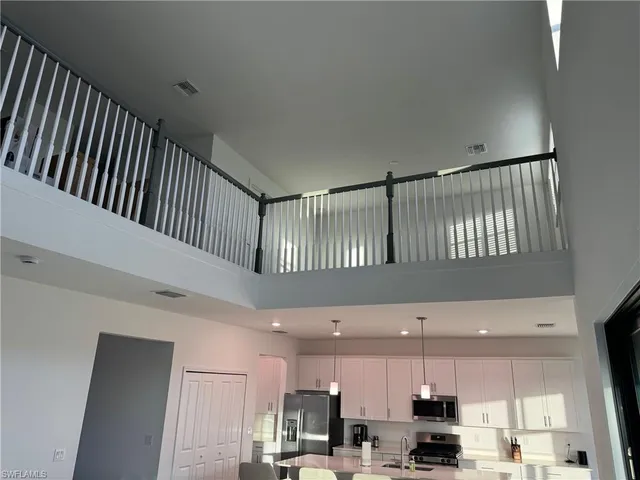 a view of kitchen with stainless steel appliances kitchen island microwave and cabinets
