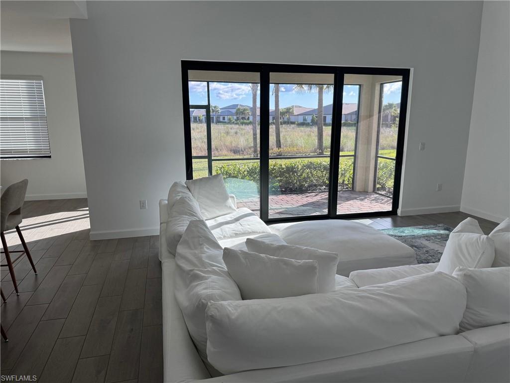 18227 Ridgeline Drive Estero, FL 33928 - Photo 10 of 30 a living room with furniture and a floor to ceiling window