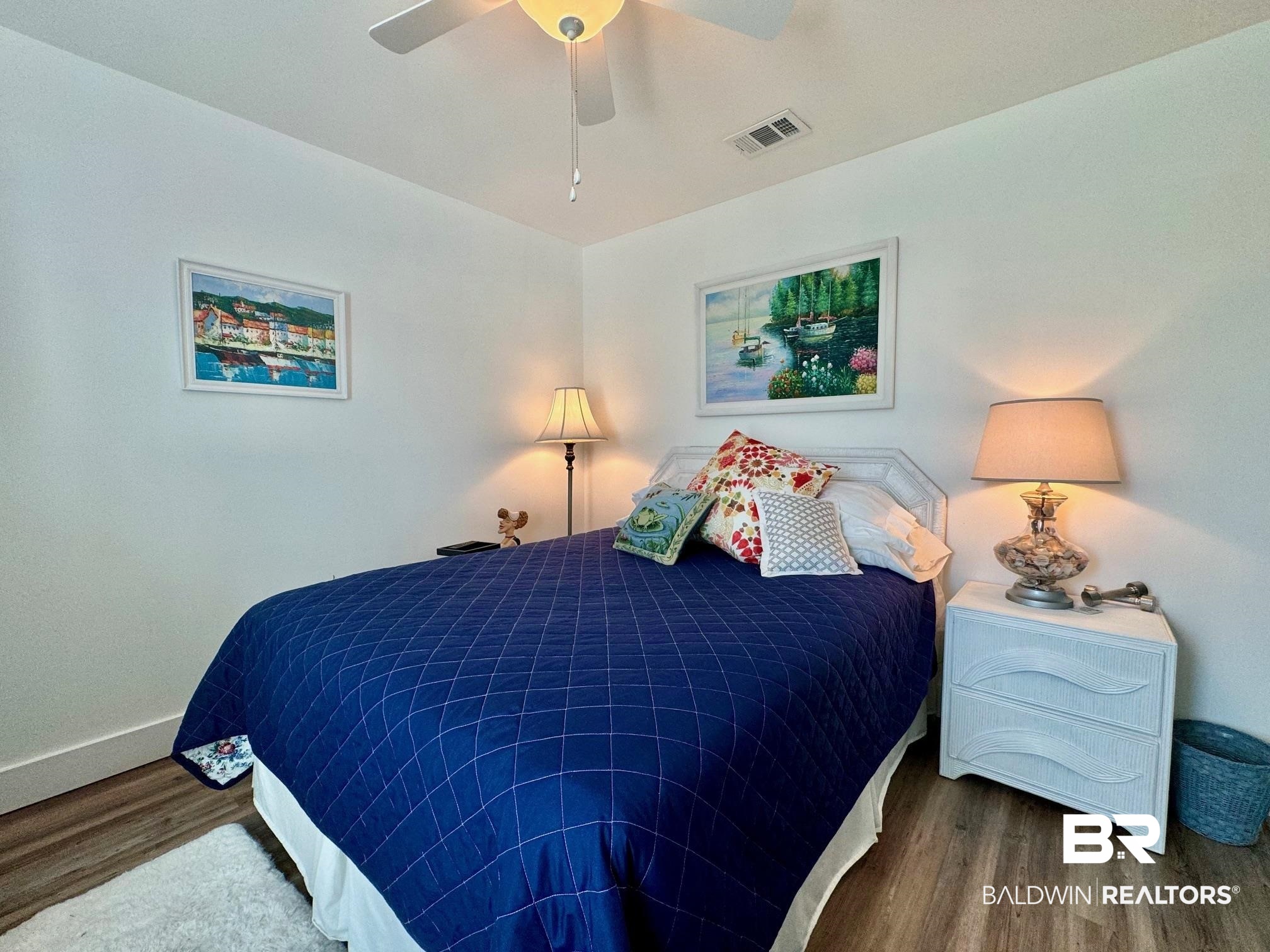 3200 Loop Road, Unit 55 Orange Beach, AL 36561 - Photo 24 of 40 Bedroom with dark wood-type flooring and ceiling fan