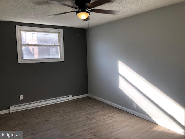 6630 North Broad Street Philadelphia, PA 19126 - Photo 11 of 12 an empty room with wooden floor and windows