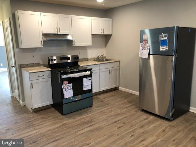 6630 North Broad Street Philadelphia, PA 19126 - Photo 3 of 12 a kitchen with stainless steel appliances granite countertop a refrigerator a sink and a stove