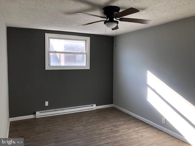 6630 North Broad Street Philadelphia, PA 19126 - Photo 9 of 12 a view of an empty room with a window and wooden floor