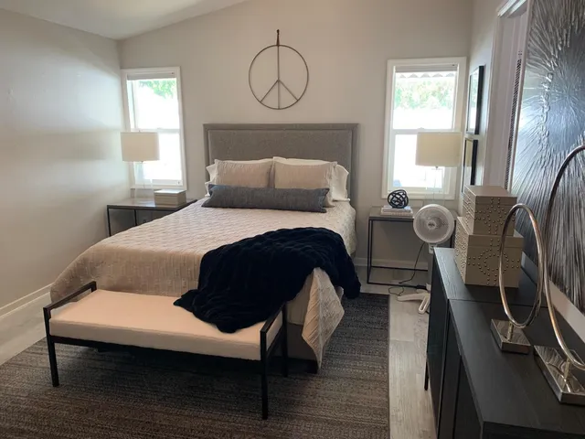 a bed room with a bed mirror and a window