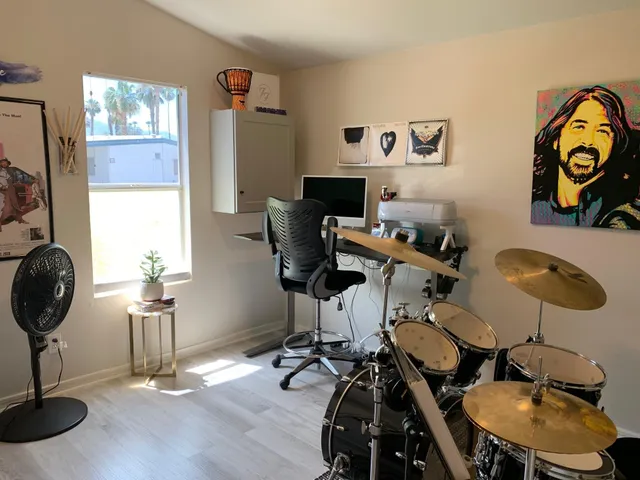 a view of a workspace with furniture and a mirror
