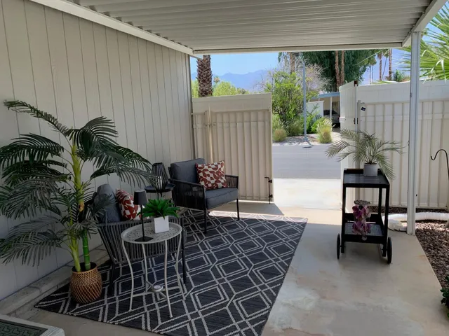 a view of a patio with table and chairs and potted plants