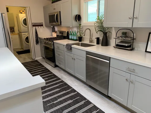 a kitchen with sink a refrigerator and cabinets