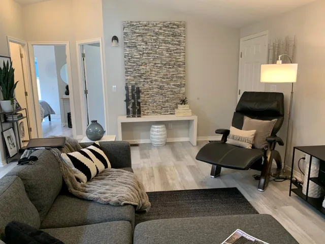 a bedroom with furniture and a large window