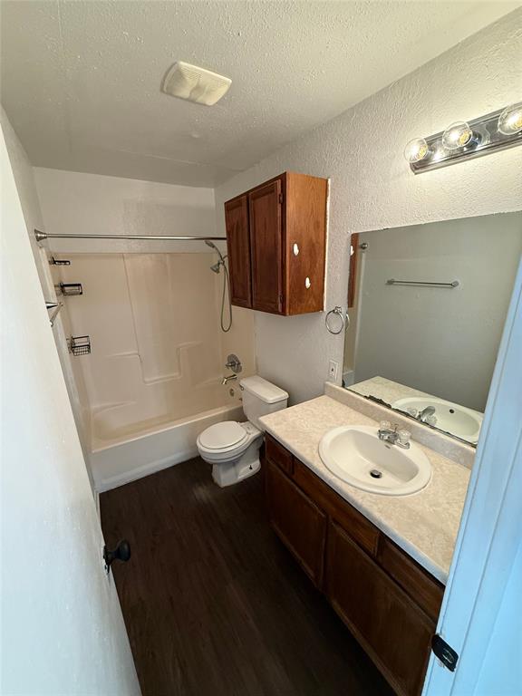 1715 Short Street, Unit D Cleburne, TX 76033 - Photo 8 of 12 Bathroom featuring a vanity with a laminate countertop, integrated sink, and wood-finish cabinetry