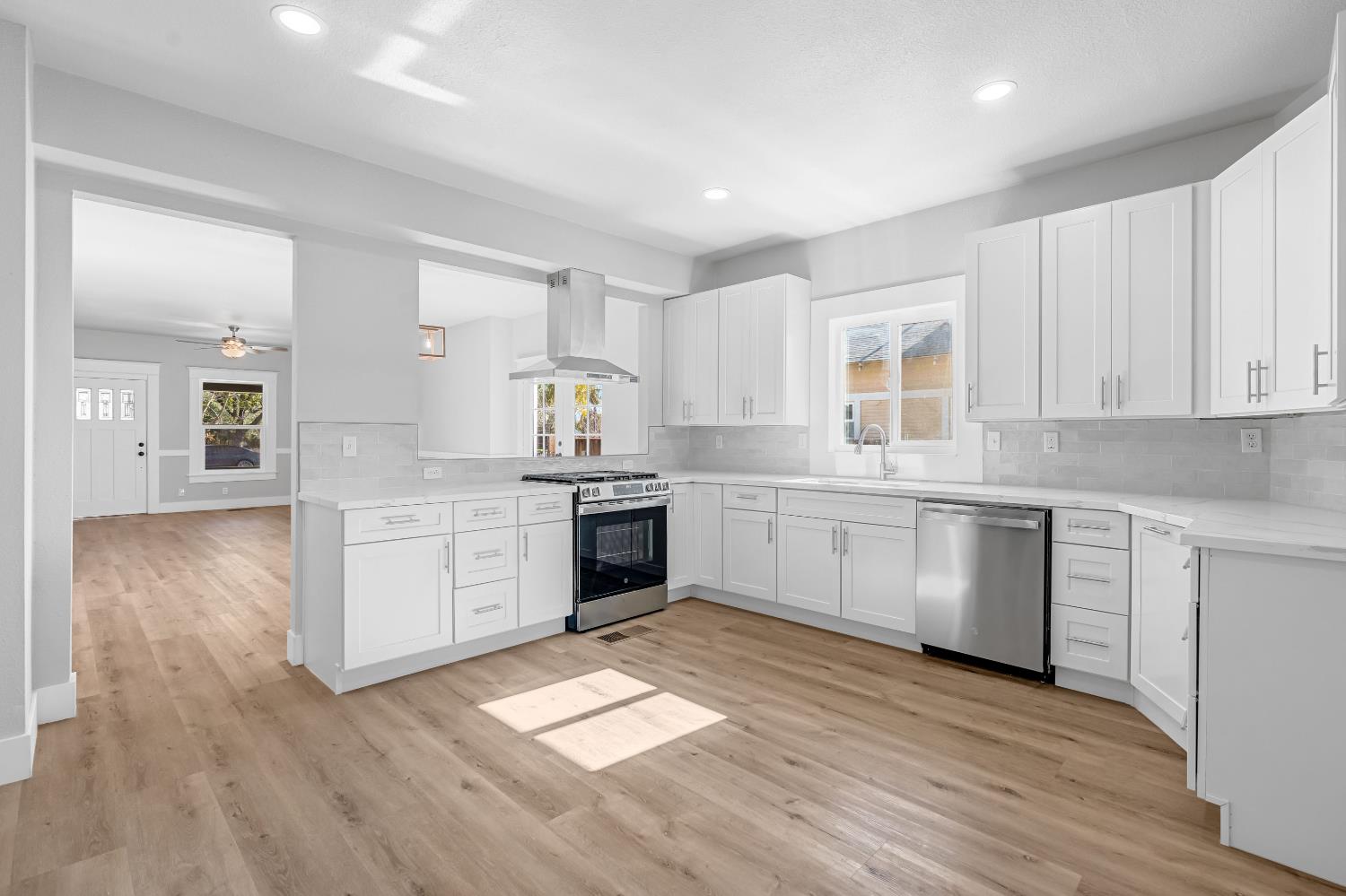 1249 D Street Reedley, CA 93654 - Photo 11 of 40 a kitchen with stainless steel appliances a white stove top oven cabinets and a window