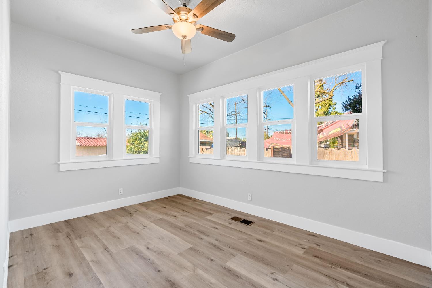 1249 D Street Reedley, CA 93654 - Photo 18 of 40 a view of an empty room with a window and wooden floor