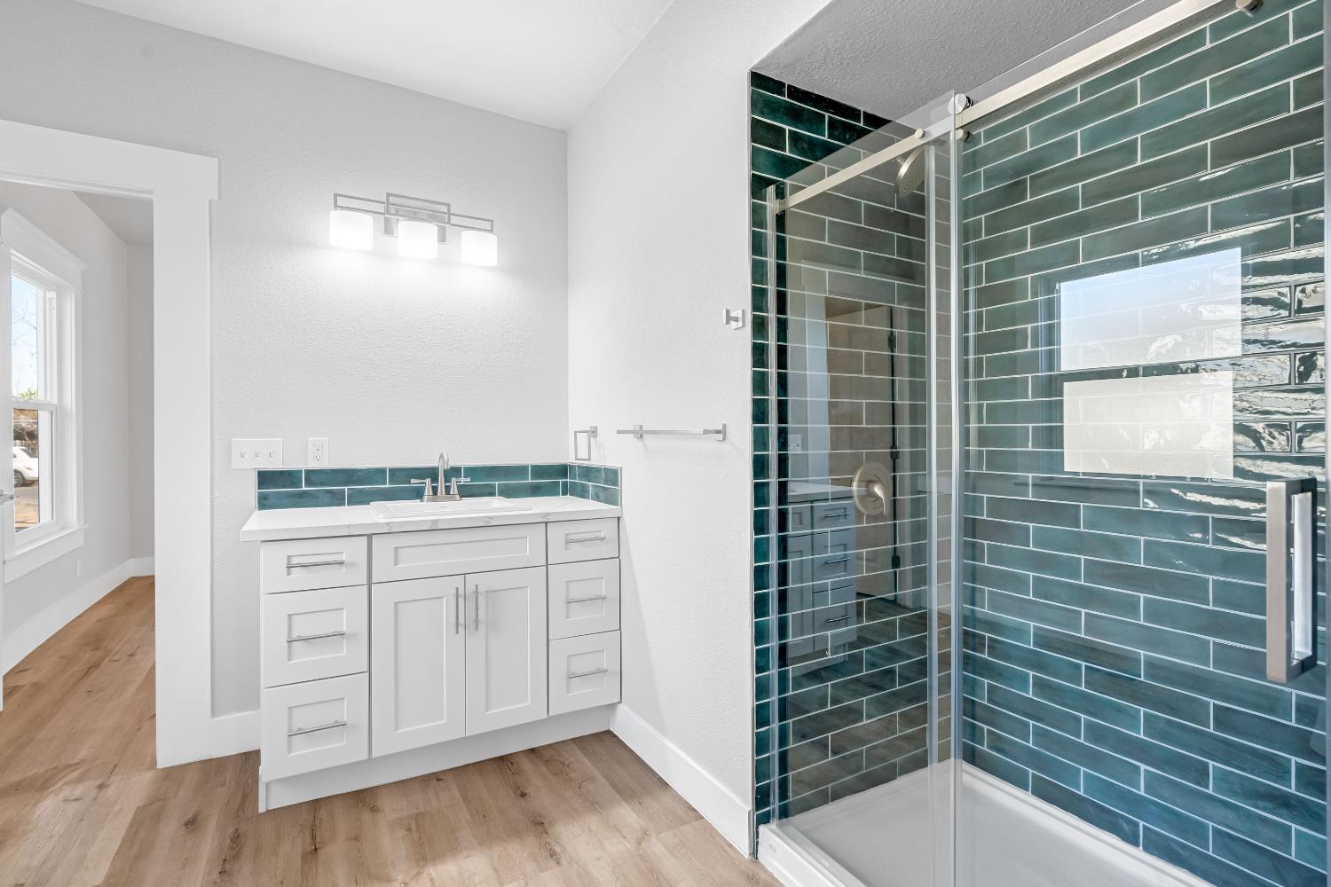 1249 D Street Reedley, CA 93654 - Photo 20 of 40 a bathroom with a shower and a sink