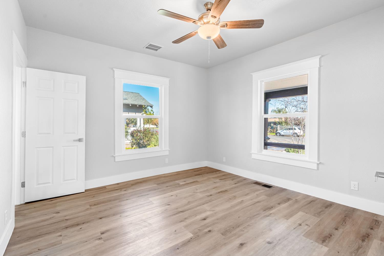 1249 D Street Reedley, CA 93654 - Photo 24 of 40 a view of an empty room with wooden floor and a window