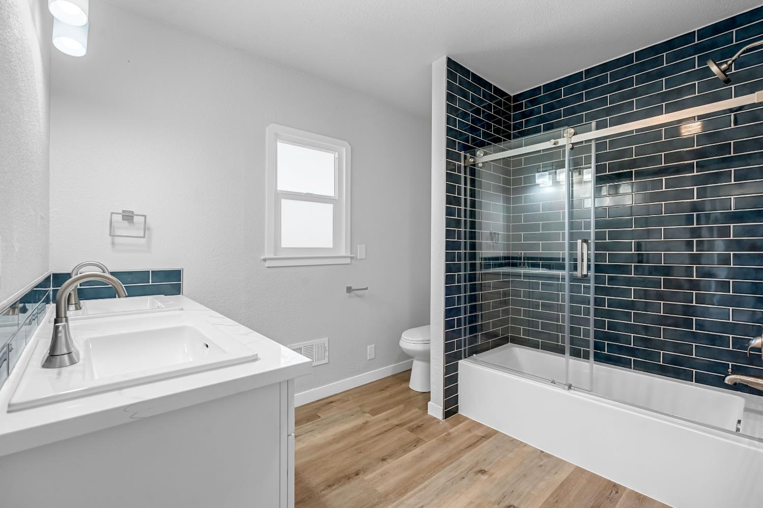 1249 D Street Reedley, CA 93654 - Photo 35 of 40 a bathroom with a bathtub and a sink