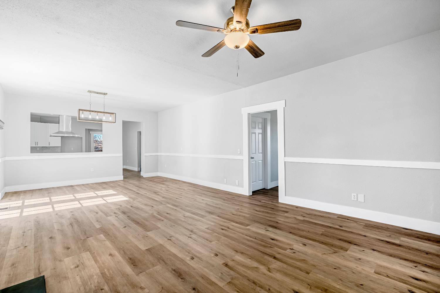 1249 D Street Reedley, CA 93654 - Photo 6 of 40 a view of empty room with wooden floor and fan