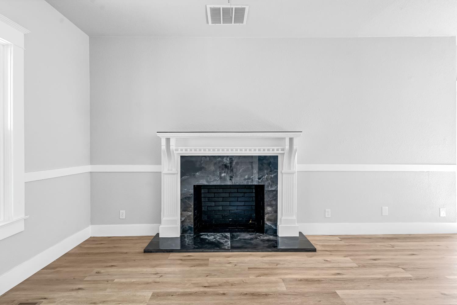 1249 D Street Reedley, CA 93654 - Photo 7 of 40 a living room with a fireplace