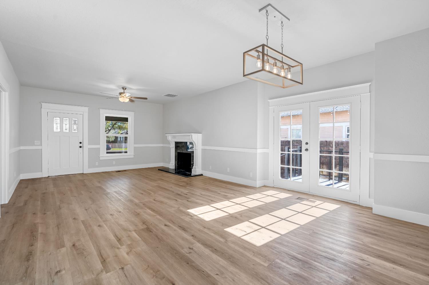 1249 D Street Reedley, CA 93654 - Photo 8 of 40 a view of empty room with wooden floor and fan