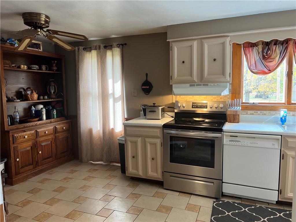 1061 Rutledge Road Transfer, PA 16154 - Photo 11 of 23 a kitchen with stainless steel appliances granite countertop a stove and a refrigerator