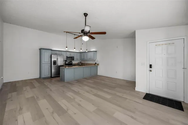 a view of a kitchen with wooden floor and window