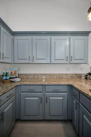 a kitchen with stainless steel appliances granite countertop a sink a stove and cabinets