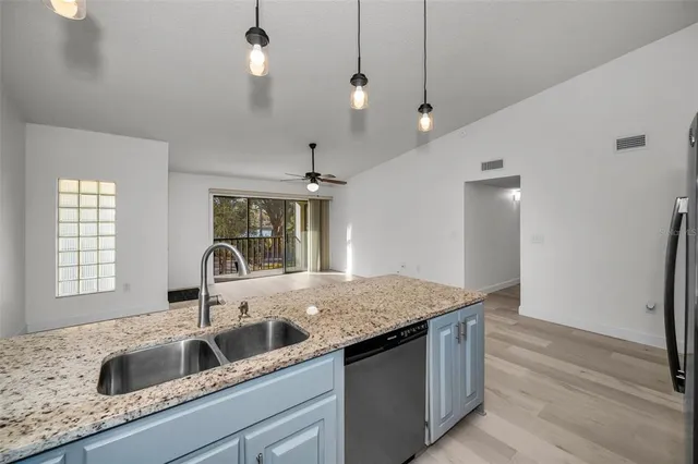 a kitchen with stainless steel appliances white cabinets and a granite counter top