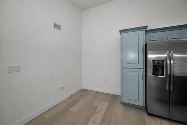 a kitchen with stainless steel appliances granite countertop a sink a stove and a refrigerator