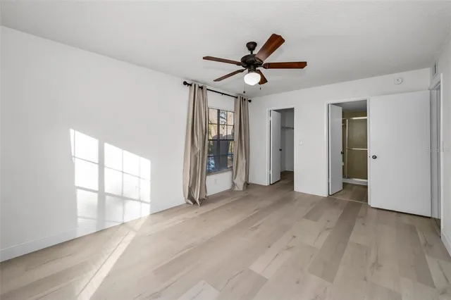 a view of empty room with wooden floor