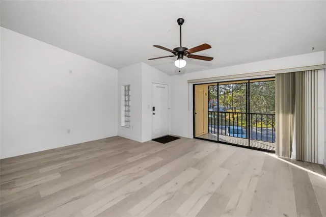 a view of a livingroom with a ceiling fan and window