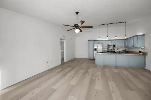 a view of a kitchen with a sink stainless steel appliances and cabinets