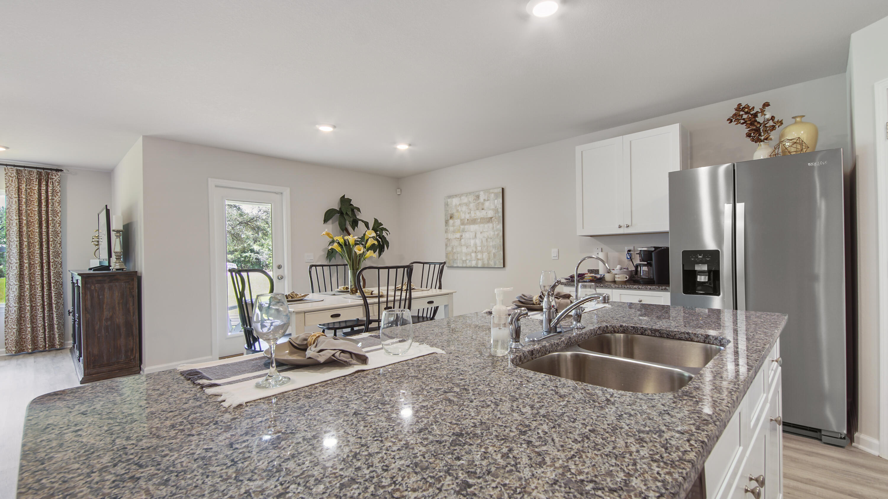 204 Gray Owl Drive Freeport, FL 32439 - Photo 5 of 35 a kitchen with stainless steel appliances granite countertop a sink refrigerator and cabinets
