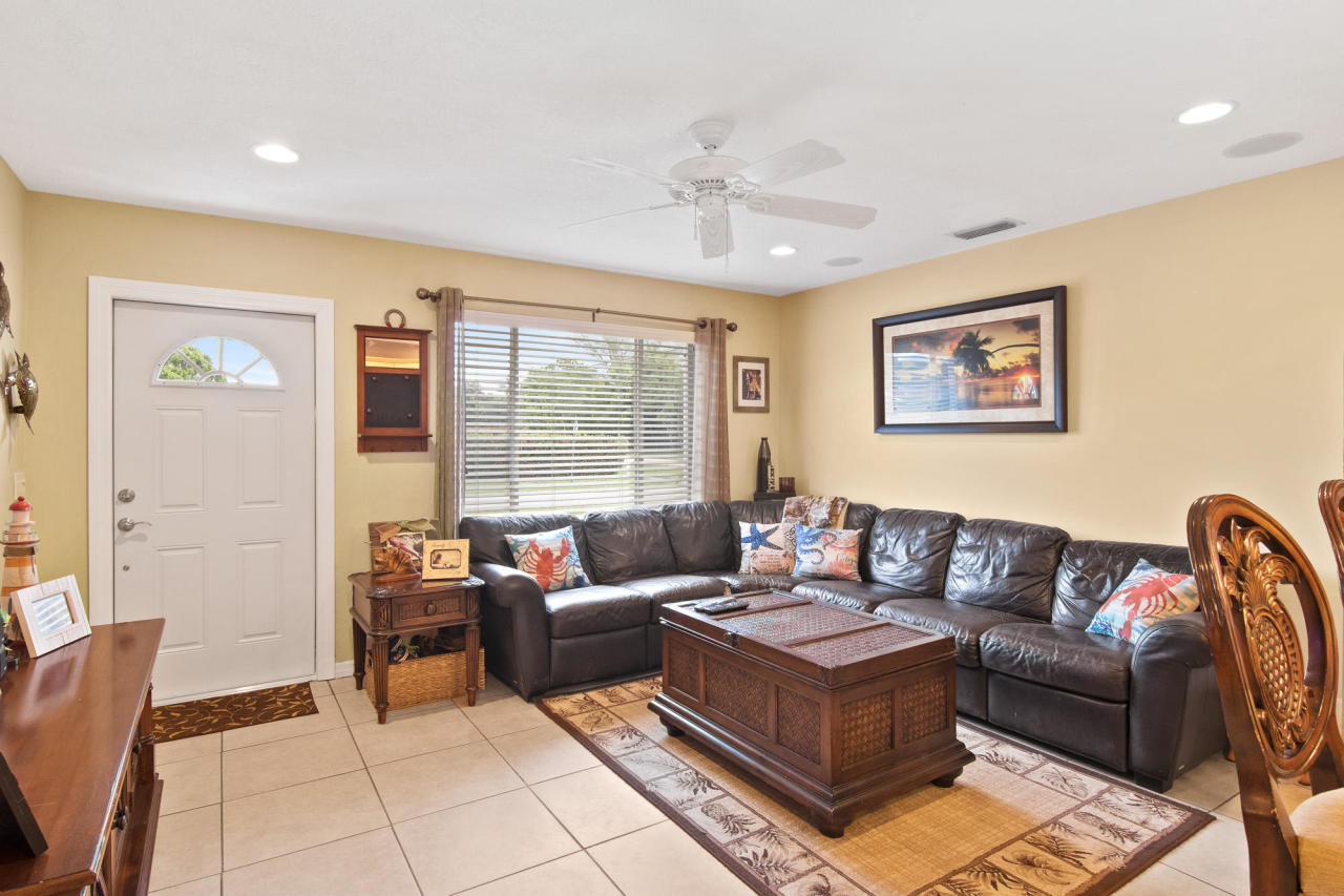 5768 Sullivan Road Jupiter, FL 33458 - Photo 3 of 18 a living room with furniture and a large window