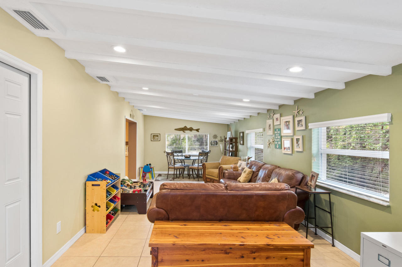 5768 Sullivan Road Jupiter, FL 33458 - Photo 6 of 18 a living room with furniture a rug and a window