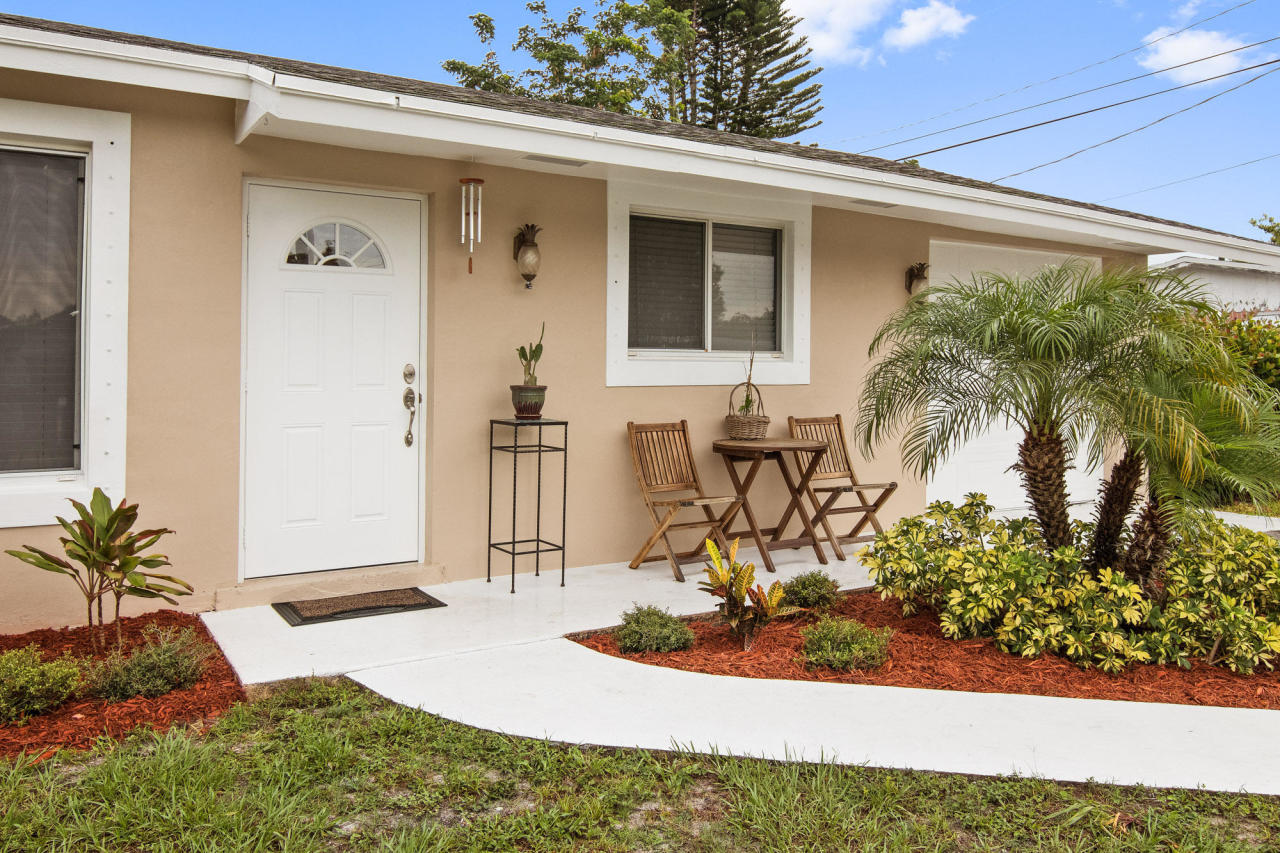 5768 Sullivan Road Jupiter, FL 33458 - Photo 8 of 18 a front view of a house with garden