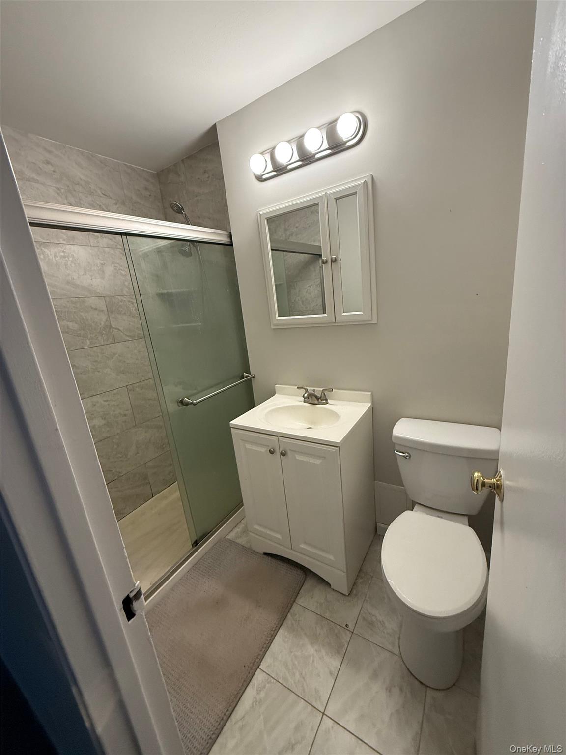 460 Old Town Road, Unit 8L Port Jefferson Station, NY 11776 - Photo 4 of 7 Full bathroom featuring a stall shower and vanity