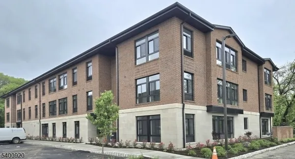 a front view of a building with a yard